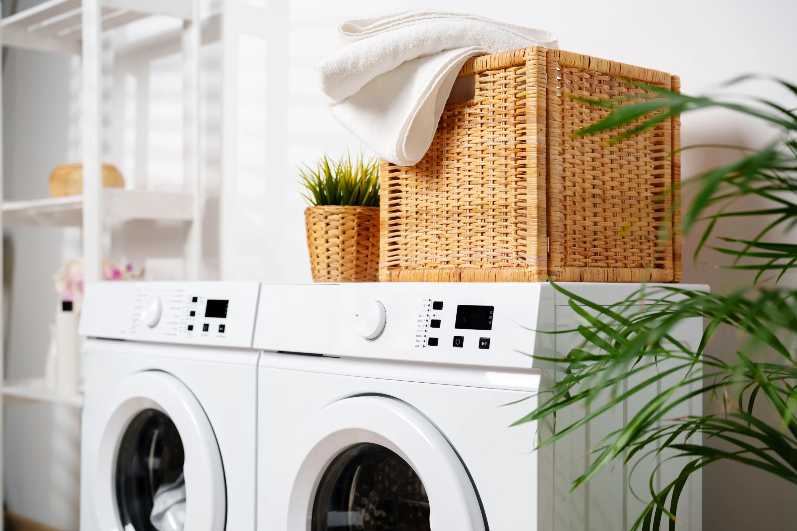 White Towels In Wicker Basket On Top Of White Washing Machine